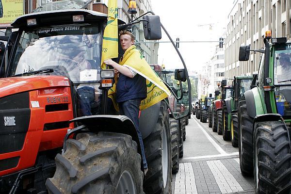Dairy farmers protest during a demonstration outside EU headquarters in Brussels, Wednesday July 22, 2009. Dairy farmers drove their tractors into the capitol to call for more government help and to cut milk quotas to lower supplies, because a 50 percent drop in milk prices over the last year is forcing them to sell below cost. (AP Photo/Jim Buell)