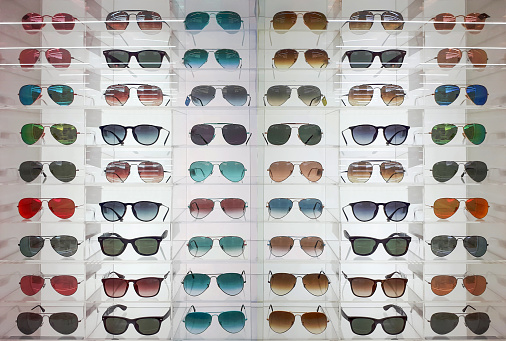 Eyeglasses and sunglasses on shelves