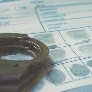 Police handcuff on fingerprint crime page file.Crime and violence concept.