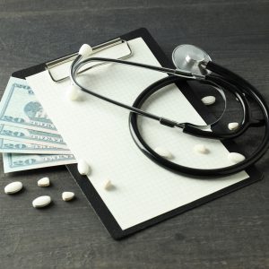 Money with medical equipment, concept of corruption in medicine.