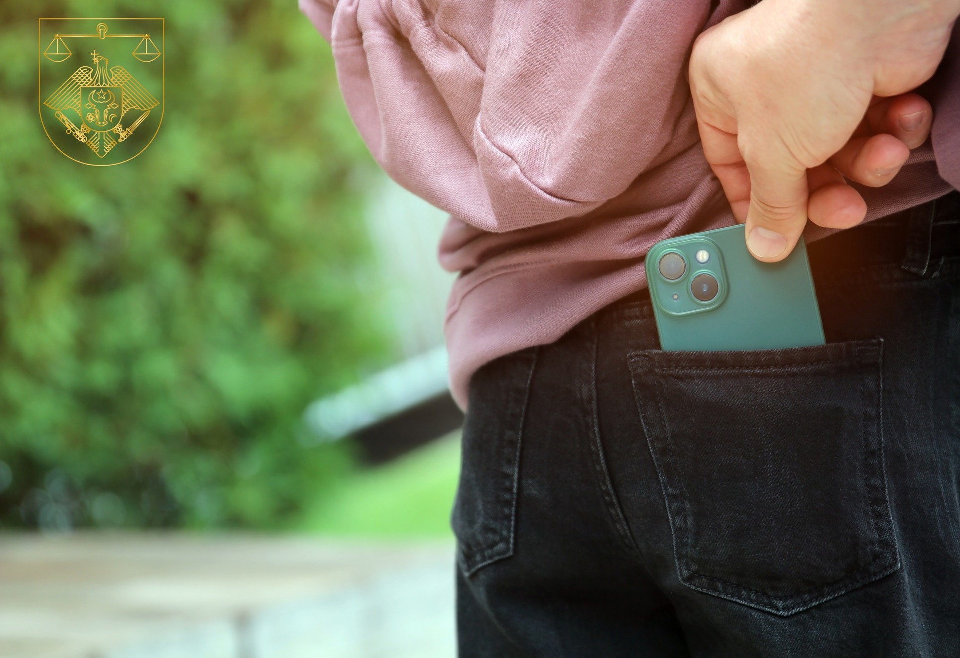 Street thief stealing mobile phone from back pocket of  woman's jeans.